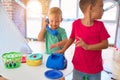 Adorable toddlers playing around lots of toys at kindergarten