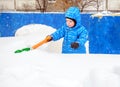 Adorable tree year old boy shoveling snow Royalty Free Stock Photo