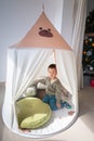 Cute toddler is playing in a kids tent at home Royalty Free Stock Photo