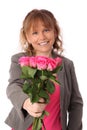 Adorable woman holding pink roses with a gift Royalty Free Stock Photo