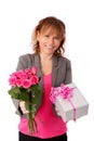 Adorable woman holding pink roses with a gift Royalty Free Stock Photo