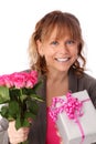 Adorable woman holding pink roses with a gift Royalty Free Stock Photo