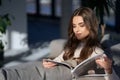 Adorable woman reading magazine on cozy sofa Royalty Free Stock Photo