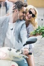 Adorable woman sitting on the scooter with her boyfriend