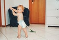 Adorable 1 year old baby boy helping with cleaning