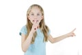 Adorable 8 years old little girl holding finger on lips symbol of hush gesture of asking to be quiet. Royalty Free Stock Photo