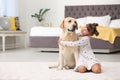 Adorable yellow labrador retriever and little girl