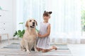 Adorable yellow labrador retriever and little girl