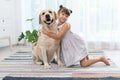 Adorable yellow labrador retriever and little girl