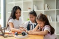 An adorable young Asian elementary school girl is focusing on studying. Kids education concept Royalty Free Stock Photo