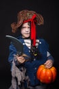 Adorable young boy dressed in a pirate outfit, playing trick or treat for Halloween