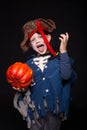 Adorable young boy dressed in a pirate outfit, playing trick or treat for Halloween