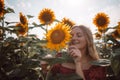 Beautiful young woman in sunflower field on summer day. Summer holidays, vacation, relax and lifestyle. Royalty Free Stock Photo