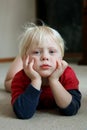 Adorable Young Child Laying on Living Room Floor Royalty Free Stock Photo