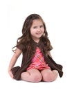 Adorable Young Child Smiling and Sitting on Her Kn