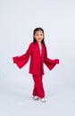 a little girl in red walking towards a camera lens to take her picture Royalty Free Stock Photo