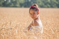 Adorable young girl on golden wheat field Royalty Free Stock Photo