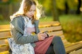 Adorable young girl having fun on beautiful autumn day. Happy teenager portrait in autumn park Royalty Free Stock Photo