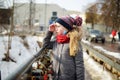 Adorable young girl having fun on beautiful winter day in Uzupis district in Vilnius, Lithuania. Cute child having a walk in Royalty Free Stock Photo