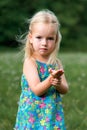 Adorable young girl holding grasshopper Royalty Free Stock Photo