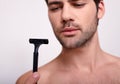 Adorable young man holds a razor Royalty Free Stock Photo