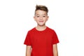 Adorable young teenage boy waist up studio portrait isolated over white background. Handsome boy looking at camera with smile. Royalty Free Stock Photo