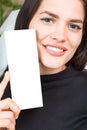 Adorable young woman holding box with empty space you can place you text or logo. Cosmetics industry. Close up portrait