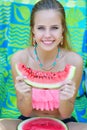 Adorable young woman holding watermelon slice