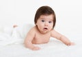 Adorably baby lie on towel in bed, white background. Happy childhood and healthcare concept Royalty Free Stock Photo