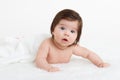 Adorably baby lie on white towel in bed. Happy childhood and healthcare concept Royalty Free Stock Photo