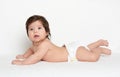 Adorably baby lie on white towel in bed. Happy childhood and healthcare concept Royalty Free Stock Photo