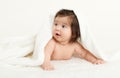 Adorably baby lie on white towel in bed. Happy childhood and healthcare concept. Yellow toned Royalty Free Stock Photo