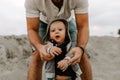 Adorably Perfect Young Father and Baby Toddler Son Family Having Fun Time at the Sandy Beach During Sunset Outside By the Ocean Wa Royalty Free Stock Photo