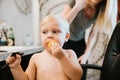 Adorably Precious Cute Little Blond Toddler Boy Showing Off His New Hair Style after Getting His First Hair Cut and Eating Candy Royalty Free Stock Photo