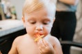 Adorably Precious Cute Little Blond Toddler Boy Showing Off His New Hair Style after Getting His First Hair Cut and Eating Candy Royalty Free Stock Photo