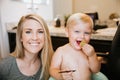 Adorably Precious Cute Little Blond Toddler Boy Showing Off His New Hair Style after Getting His First Hair Cut and Eating Candy Royalty Free Stock Photo