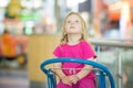 Adorble baby sit on shopping cart in mall Royalty Free Stock Photo