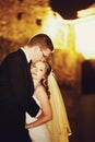 Adorning elegant fashion groom and bride is kissing on the back Royalty Free Stock Photo