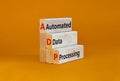 ADP automated data processing symbol. Concept words ADP automated data processing on blocks on a orange table, orange background. Royalty Free Stock Photo