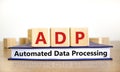 ADP automated data processing symbol. Concept words ADP automated data processing on cubes on book on a beautiful white background Royalty Free Stock Photo