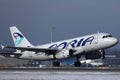 Adria Airways plane taking off, snow on runway