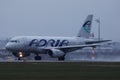 Adria Airways plane taxiing on runway