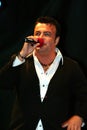 Adrian Enache singing on a stage in front of the spectators. Royalty Free Stock Photo