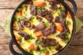 Adriatic cuisine Balsica tava beef with vegetables baked in egg sour cream sauce close-up in a frying pan. horizontal top view Royalty Free Stock Photo