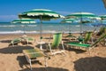 Adriatic Sea coast view. Seashore of Italy, summer umbrellas on sandy beach with clouds on horizon. Royalty Free Stock Photo