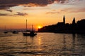 Adriatic sea with some boats sailing and the view of the croatian houses of Rovinj, Croatia, and the bell tower of the Church of Royalty Free Stock Photo