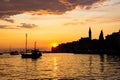 Adriatic sea with some boats sailing and the view of the croatian houses of Rovinj, Croatia, and the bell tower of the Church of Royalty Free Stock Photo