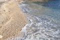 Adriatic shore with sandy beach and advancing wave. Beautiful view on a wave and Adriatic Sea.