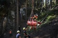 Emergency medical doctor suspended from rope under helicopter