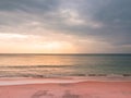 Adstract color of pink beach in golden sunset at the beach. dramatic gray cloudy sky above sea water